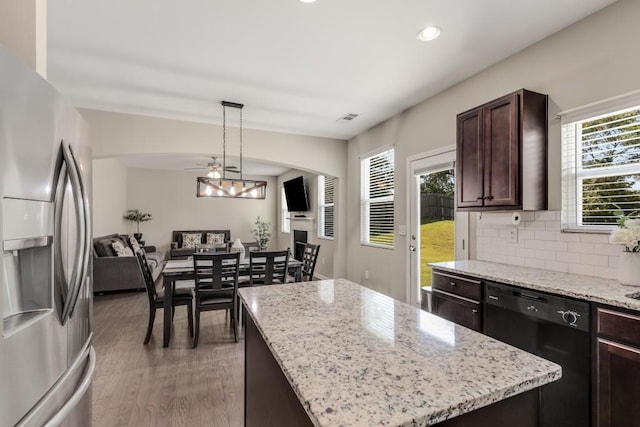 kitchen with dishwasher, a center island, stainless steel refrigerator with ice dispenser, ceiling fan, and decorative light fixtures