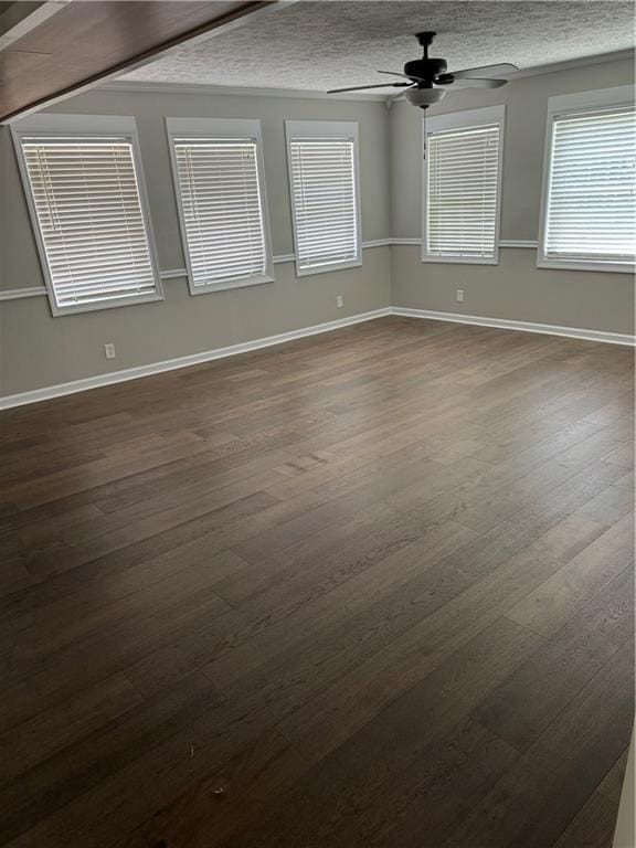 spare room featuring ceiling fan, dark hardwood / wood-style flooring, and a textured ceiling