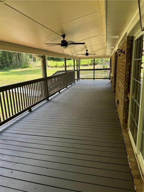 wooden deck featuring ceiling fan and covered porch