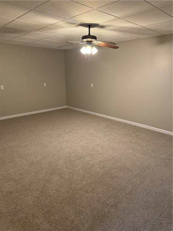 carpeted empty room featuring a drop ceiling and ceiling fan