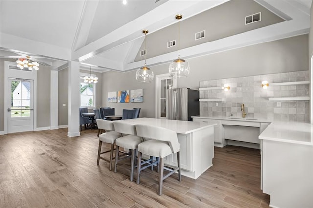 352 Foxglove Way, Mcdonough, GA 30253 - kitchen with freestanding refrigerator, a sink, a chandelier, a kitchen island, and open shelves