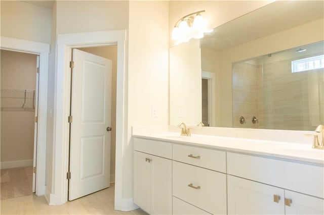 bathroom with vanity and tiled shower