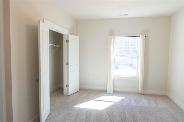 unfurnished bedroom featuring light colored carpet