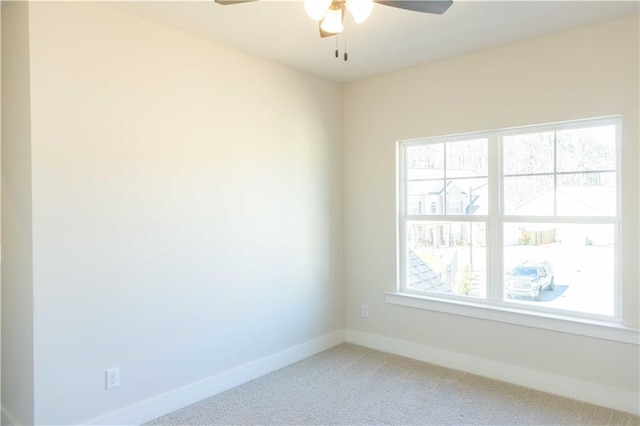 carpeted spare room with a healthy amount of sunlight and ceiling fan