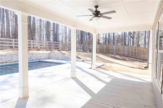 view of patio featuring a fenced in pool and ceiling fan