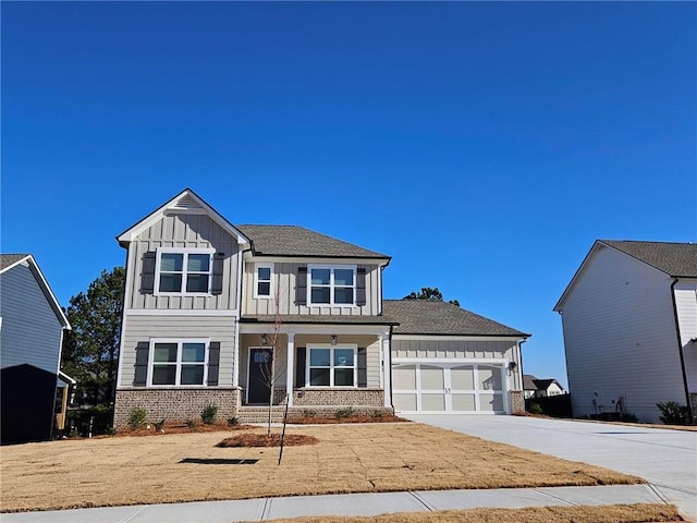 craftsman-style house featuring brick siding, board and batten siding, concrete driveway, and a garage