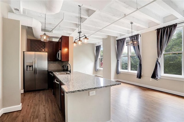 32 Peachtree St NW Unit 308, Atlanta, GA 30303 - kitchen featuring appliances with stainless steel finishes, sink, decorative backsplash, hardwood / wood-style flooring, and light stone counters