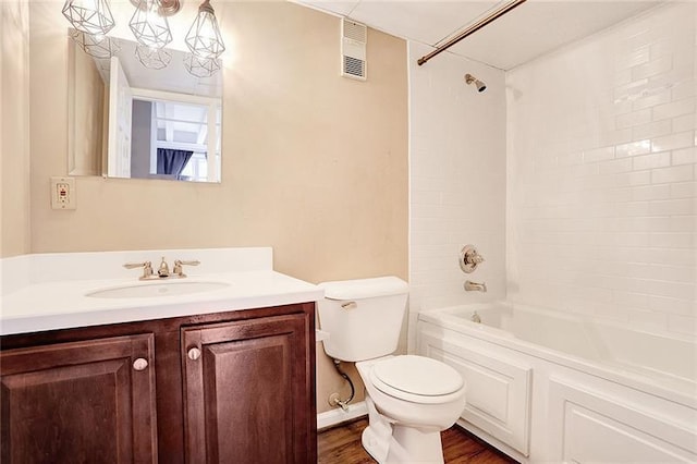 full bathroom featuring vanity, hardwood / wood-style floors, bathing tub / shower combination, and toilet