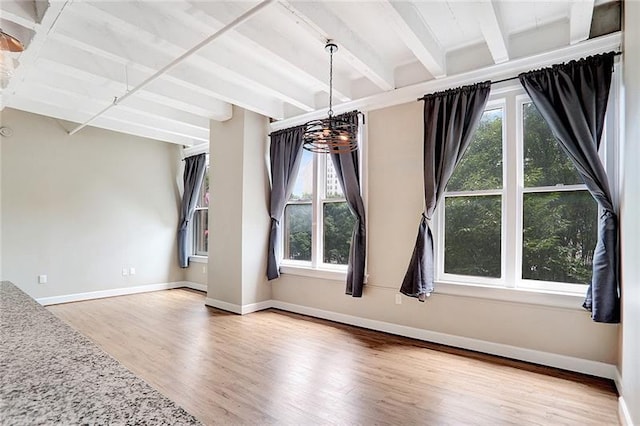 interior space featuring an inviting chandelier, wood-type flooring, and beam ceiling