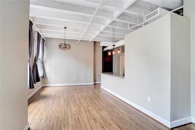 spare room with hardwood / wood-style floors and beam ceiling