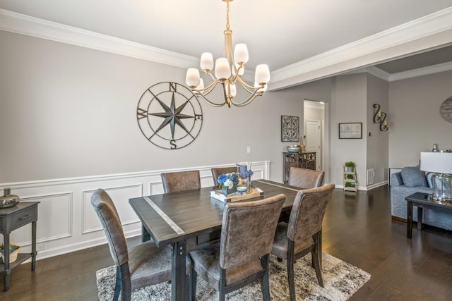 dining area featuring an inviting chandelier, ornamental molding, and dark wood finished floors
