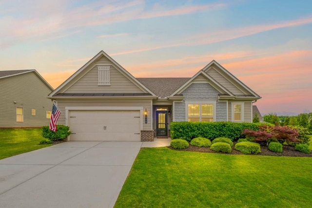 view of front of home featuring a garage, a standing seam roof, a yard, and driveway