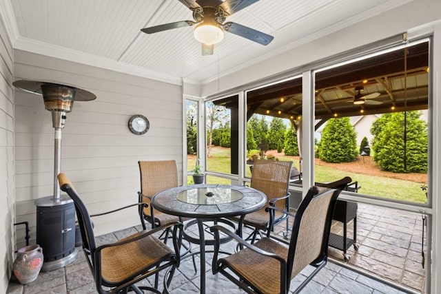 sunroom / solarium featuring outdoor dining area and ceiling fan