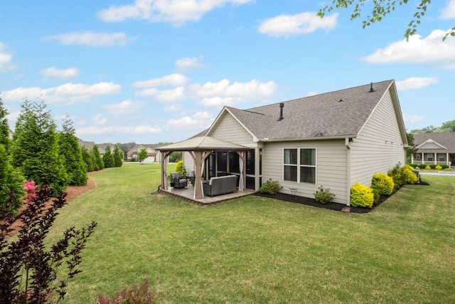 back of property with a lawn, a patio, a gazebo, and a shingled roof