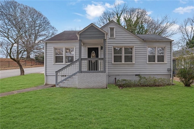 bungalow-style home featuring a front lawn