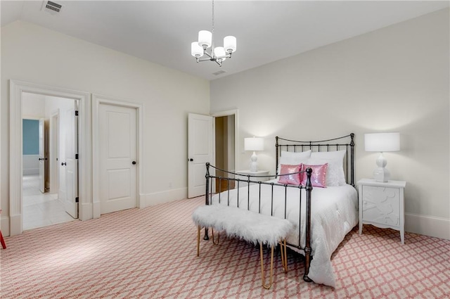 carpeted bedroom with vaulted ceiling and a chandelier