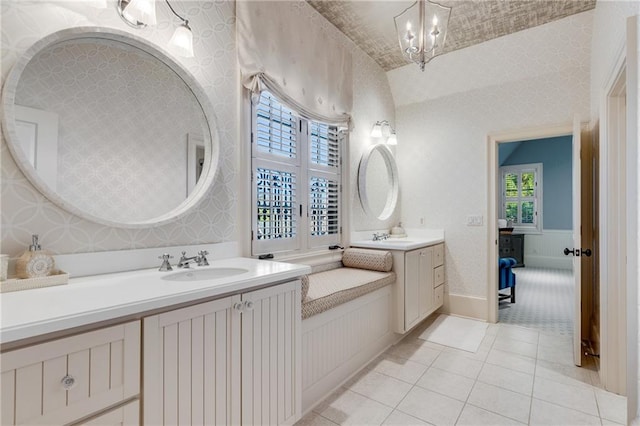 bathroom featuring tile flooring, an inviting chandelier, and double vanity