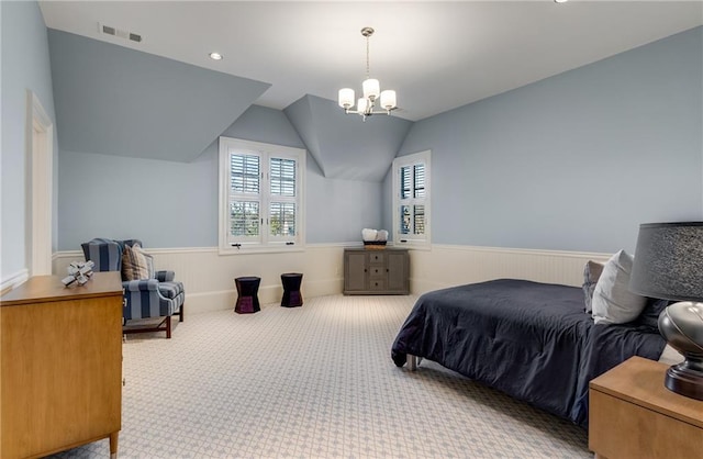 bedroom with carpet flooring, vaulted ceiling, and an inviting chandelier