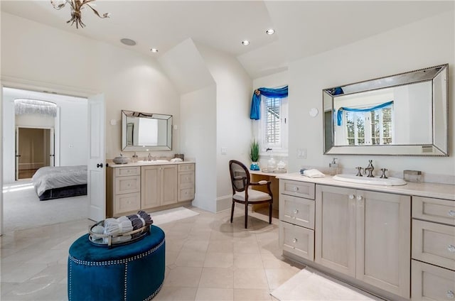 bathroom with dual sinks, tile flooring, vaulted ceiling, and vanity with extensive cabinet space