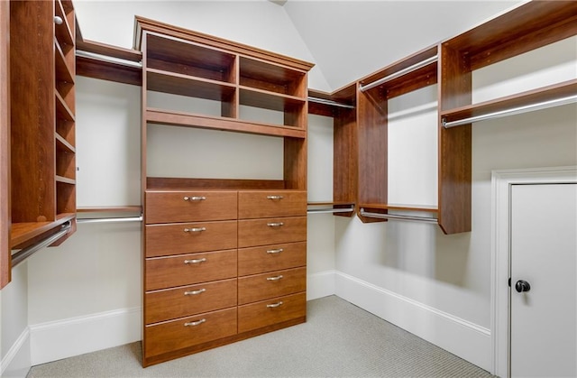 walk in closet with lofted ceiling and carpet flooring