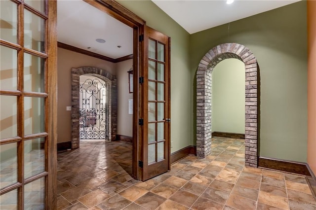 tiled foyer featuring ornamental molding and french doors