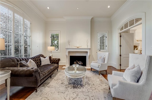 living room featuring a high end fireplace, crown molding, and wood-type flooring