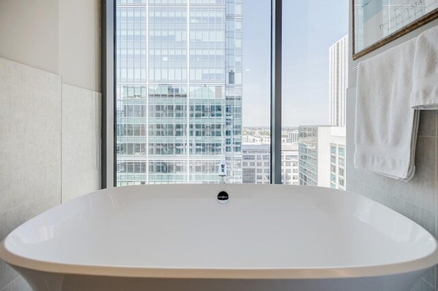 dining area with a city view and tile walls