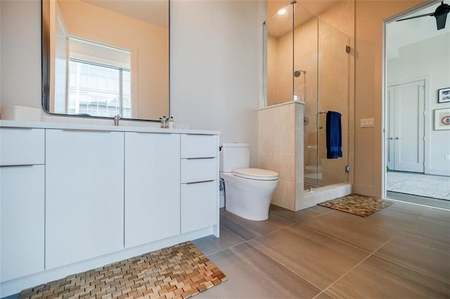 full bath with vanity, a stall shower, tile patterned flooring, and toilet