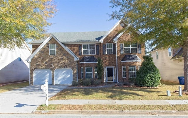 view of front of property with a garage and a front lawn