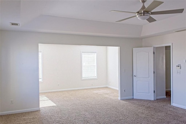 empty room with ceiling fan and light colored carpet