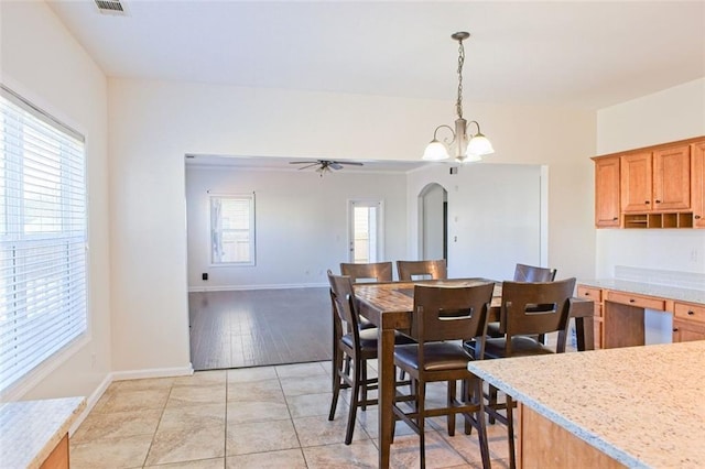 dining space featuring ceiling fan with notable chandelier, light wood-type flooring, and plenty of natural light