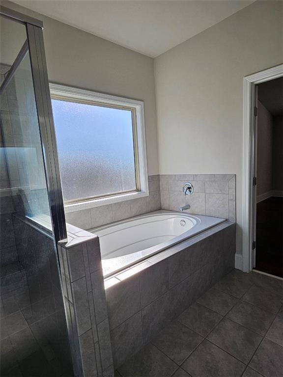 full bath featuring tile patterned floors, a garden tub, and a shower stall