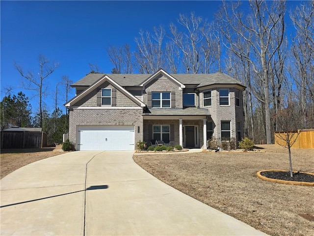 view of front facade featuring brick siding, concrete driveway, a garage, and fence