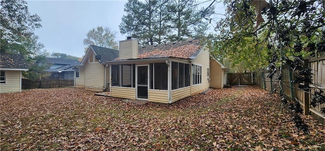 rear view of property with a sunroom