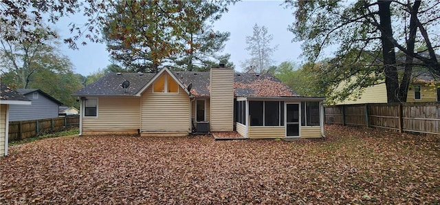 rear view of property featuring a sunroom