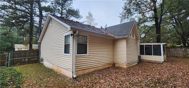 view of property exterior with a sunroom