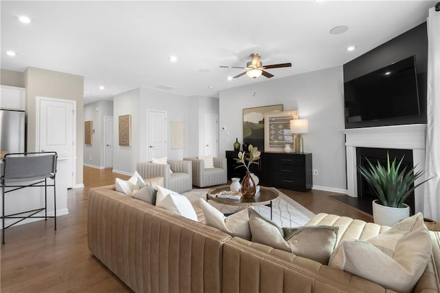 living room with dark hardwood / wood-style floors and ceiling fan