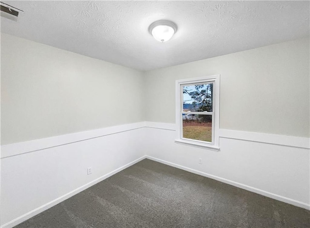 spare room with carpet flooring and a textured ceiling