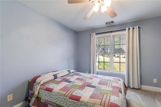 bedroom featuring carpet floors, visible vents, baseboards, and a ceiling fan