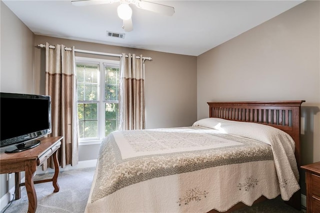 bedroom with ceiling fan, multiple windows, visible vents, and light colored carpet