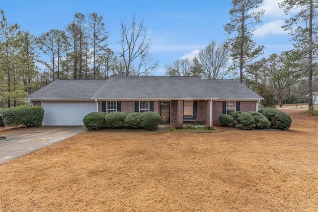 single story home featuring an attached garage, driveway, roof with shingles, and brick siding