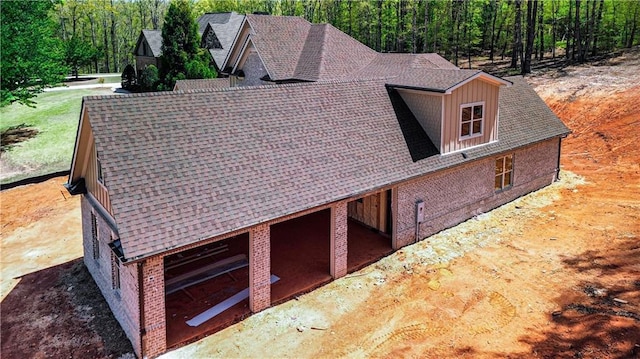 exterior space featuring a wooded view