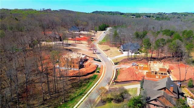 birds eye view of property with a wooded view