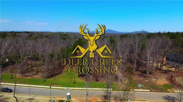 community sign featuring a forest view