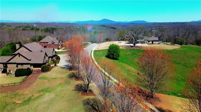 birds eye view of property featuring a forest view
