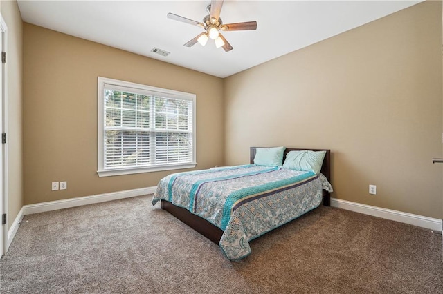 carpeted bedroom with ceiling fan, baseboards, and visible vents