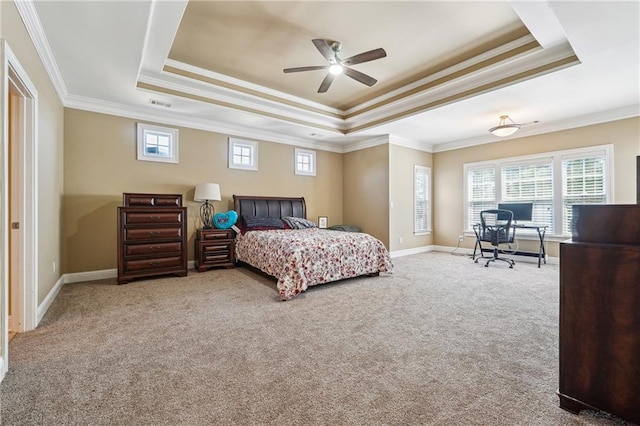 carpeted bedroom with crown molding, multiple windows, and a raised ceiling