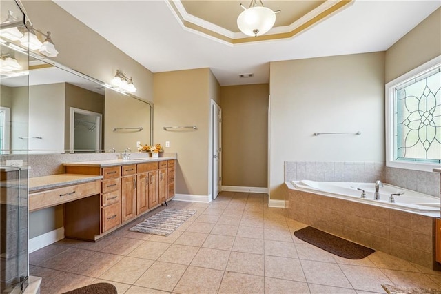 full bath with a tray ceiling, visible vents, tile patterned flooring, a garden tub, and vanity