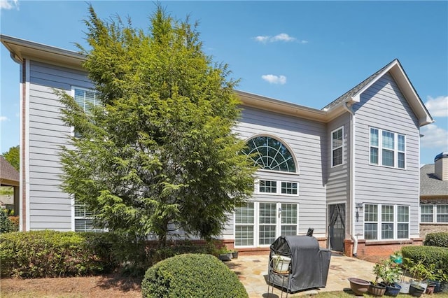 rear view of property featuring a patio area