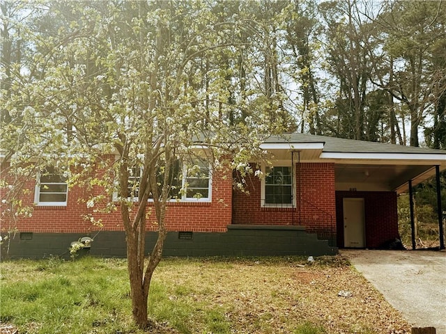 view of front of home with a carport, crawl space, concrete driveway, and brick siding